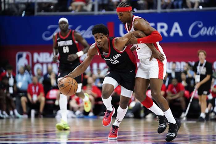 Trail Blazers guard Scoot Henderson (00) dribbles the ball against Houston Rockets guard/forward Nate Hinton (62) during the first half at Thomas & Mack Center.